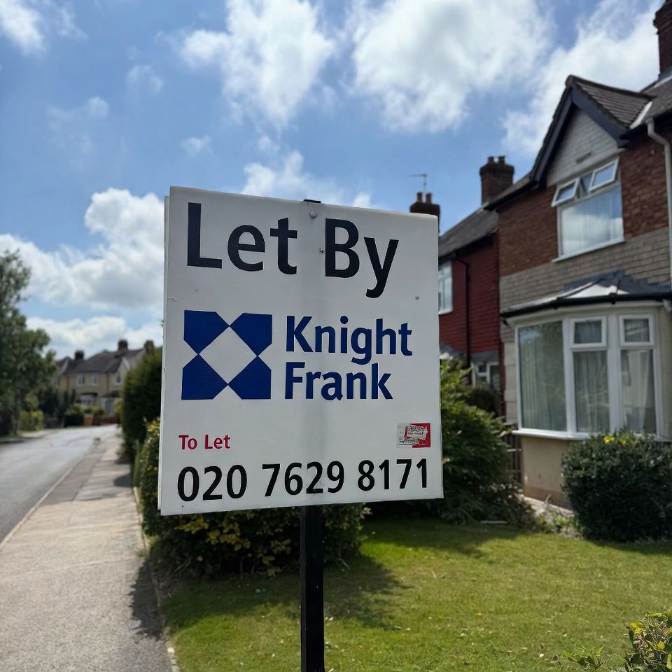 Let By estate agent board outside a British home